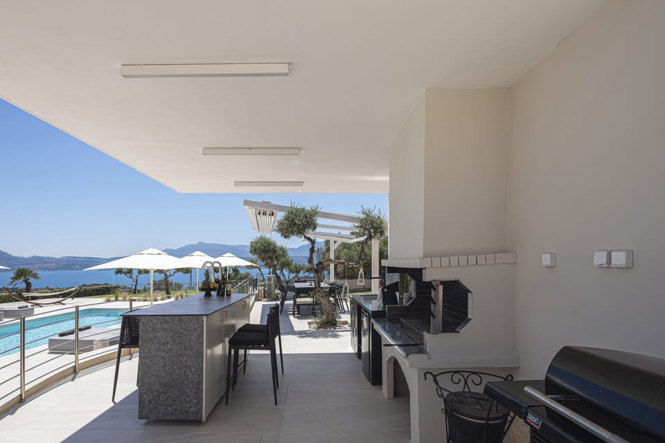 Fire up the charcoal BBQ under the shaded pergola, complete with a sink, mini-fridge, and dining table for eight.