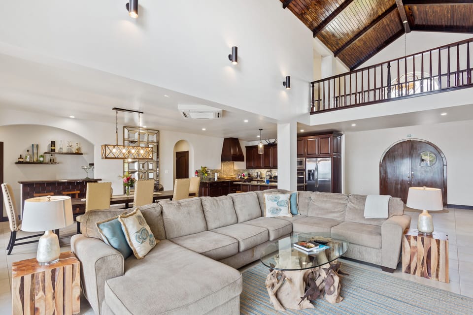Living area with huge, comfy sofa, ceiling fan, A/C, TV