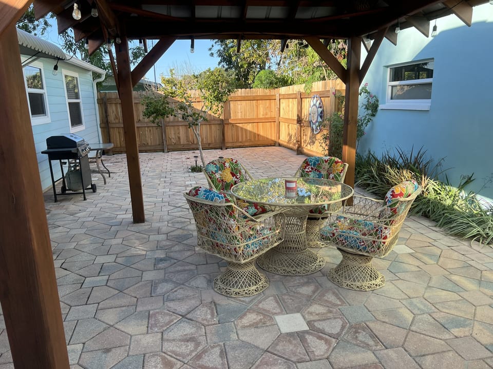 Private fenced in yard with tiki hut and lights