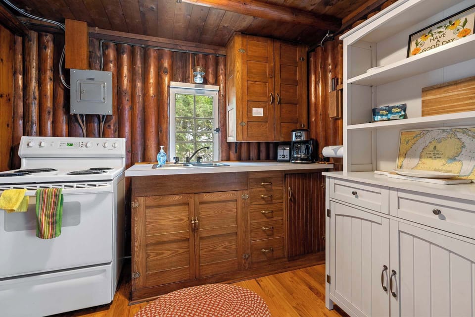Kitchen with stove, fridge, microwave, and coffee maker