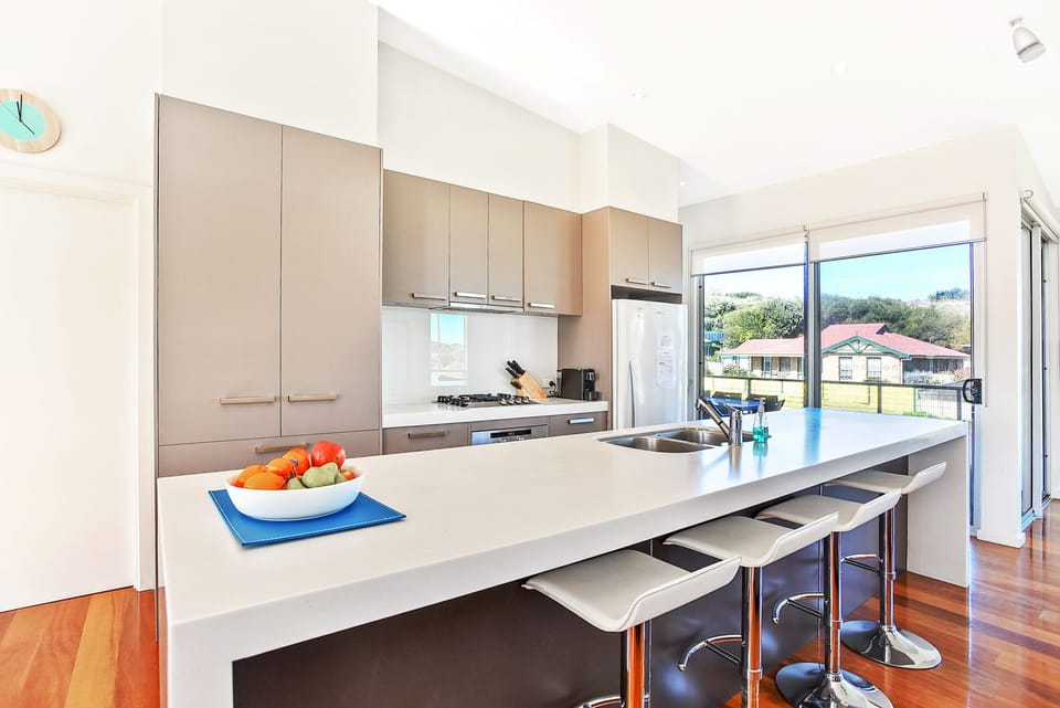 A fully-equipped kitchen includes a dishwasher, oven, microwave, and all the tools needed to prepare shared meals with ease. 