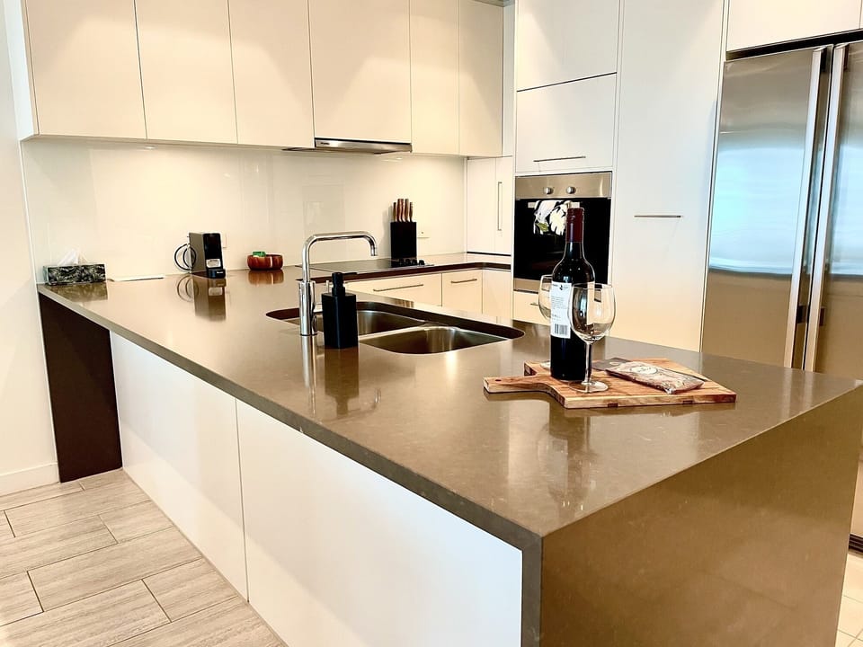 Contemporary kitchen with modern appliances and ample bench space, ideal for preparing meals with ease, enhancing the self-catering experience.