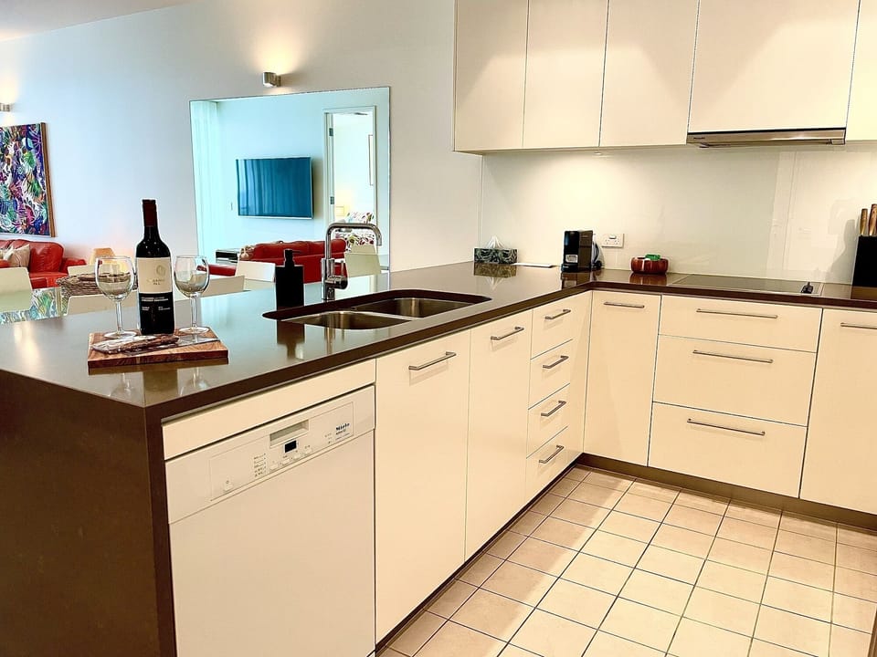 Contemporary kitchen with modern appliances and ample bench space, ideal for preparing meals with ease, enhancing the self-catering experience.