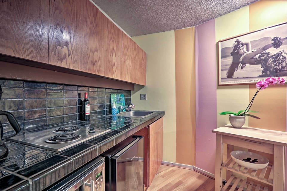 The space includes a stovetop, microwave, mini-fridge, and coffee maker!