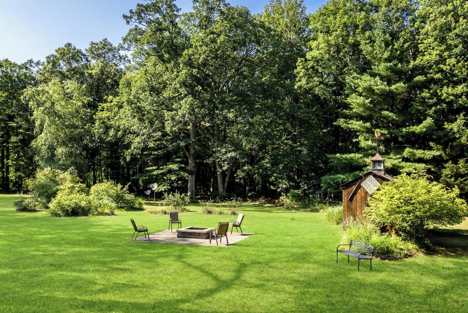 Get warm by the White Oaks Haven fire pit in the spacious back yard (photo taken Aug 2024)