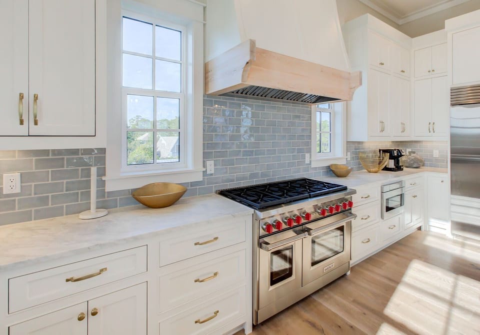 Chef's style kitchen with gas range & hood.