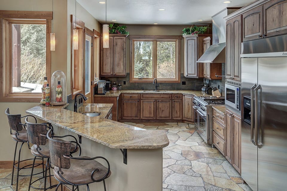Gourmet kitchen with dacor commercial fridge, viking range, two ovens.