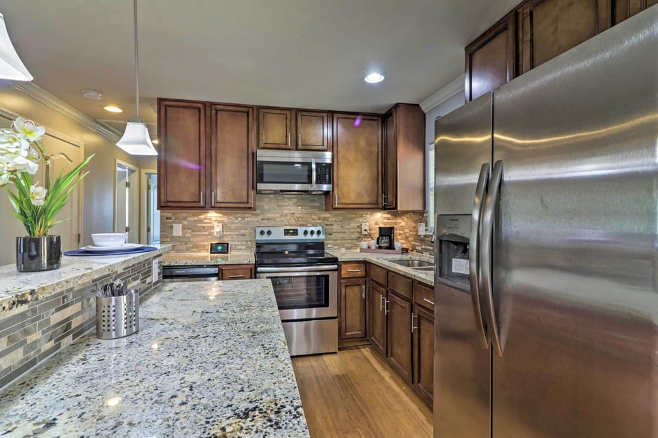Modern appliances and granite countertops elevate this full kitchen.