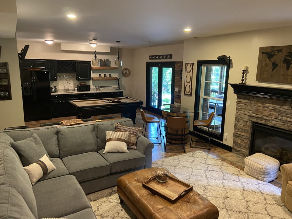 2nd family room in finished walkout basement with fireplace and game/bar area.