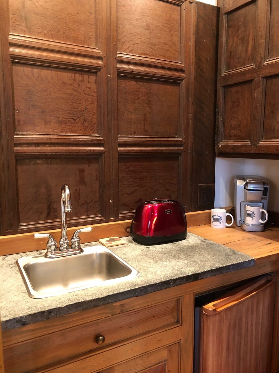 Concealed 'kitchenette' area with sink, under counter refrigerator and lots more
