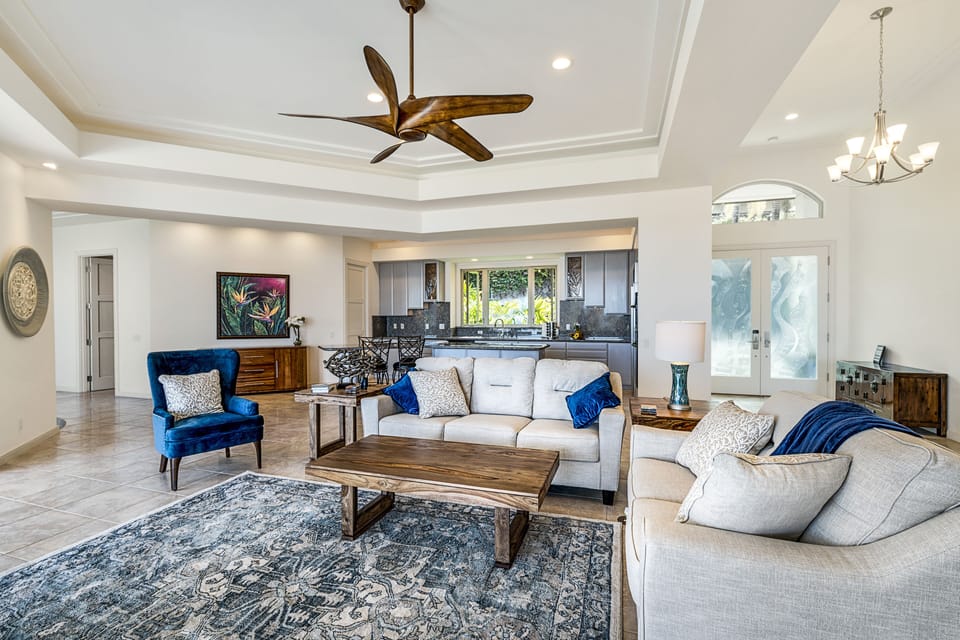 Open living room with vaulted ceilings, ceiling fans, and comfortable seating for gathering.
