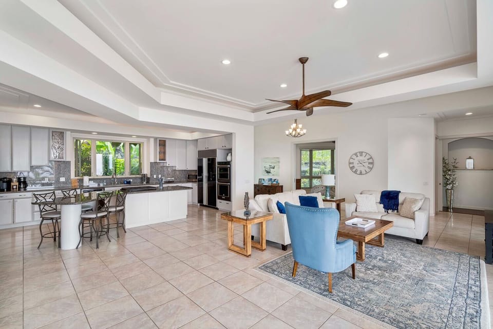 Open-concept living area with vaulted ceilings connecting the lounge and kitchen.