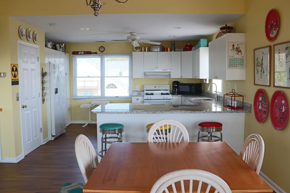 Your fully equipped kitchen opens to a cheerful dining area where you'll gather for home-cooked meals and morning coffee together.