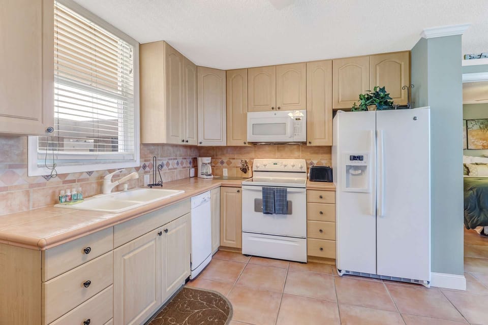 Open kitchen with full sized appliances and all the basics needed for vacation meal preparation.