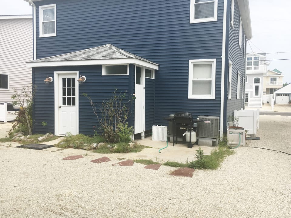 Outside back, shares laundry room and outdoor shower, have own grill