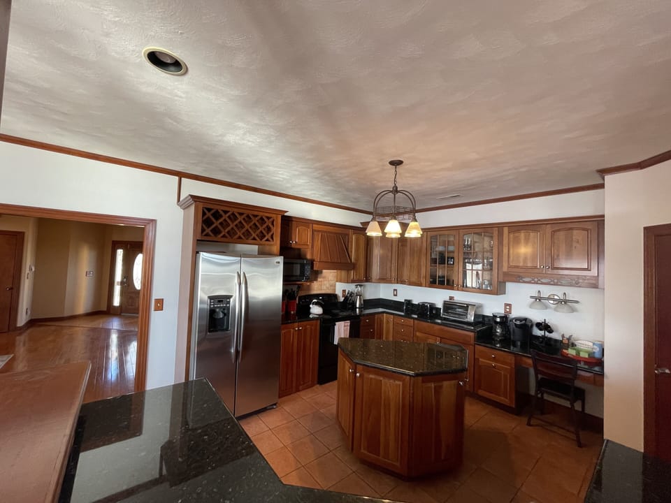 Large kitchen open to living and dining room with views of Back Bay