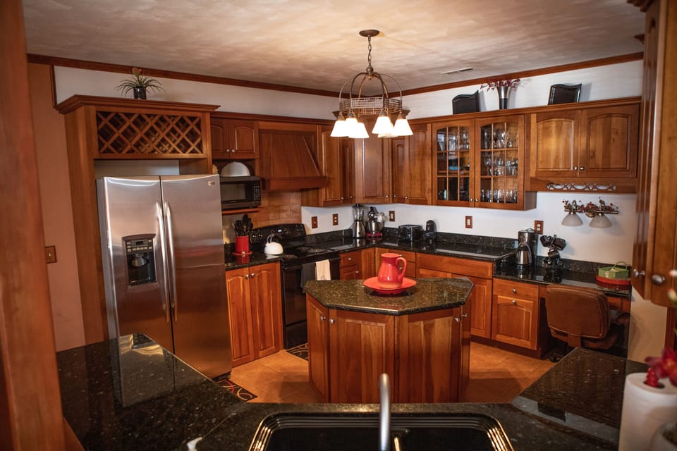 Large kitchen open to living room and dining room with views of Back Bay