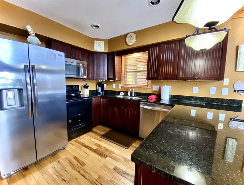 Modern, well appointed kitchen with stainless steel appliances and granite countertops