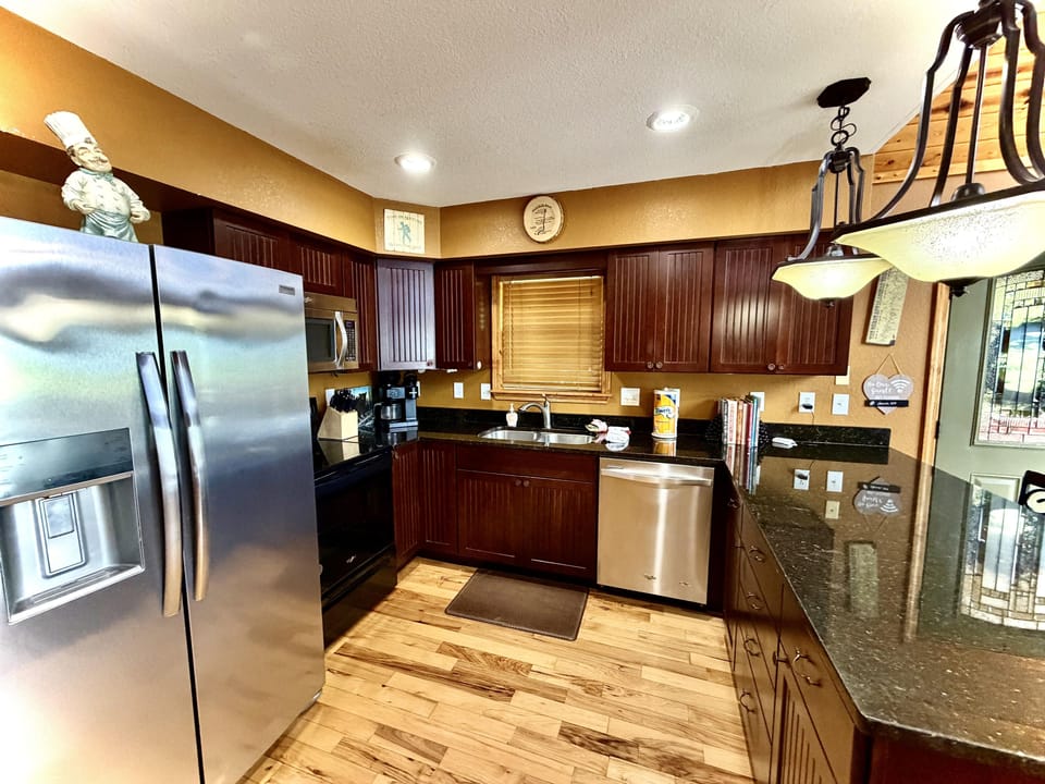 Modern, well appointed kitchen with stainless steel appliances and granite countertops