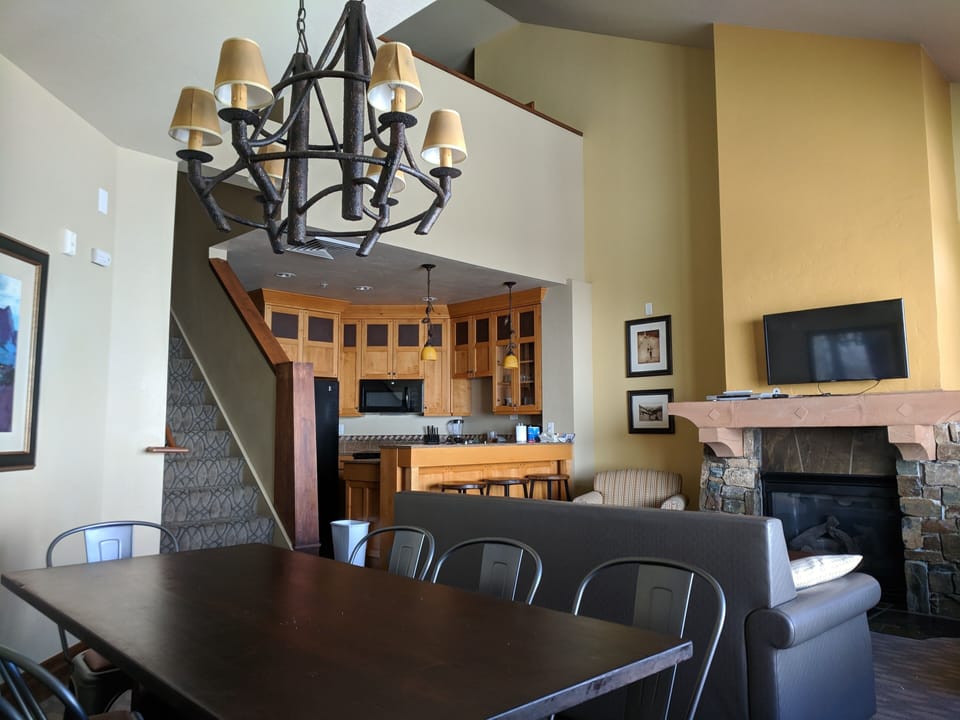 View of Living Room /Dining Area into Kitchen.  Stairs go up to loft/3rd BR/BA