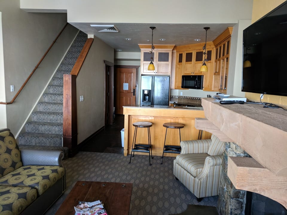 Living Room into Kitchen.  Stairs up to loft 3rd BR/BA