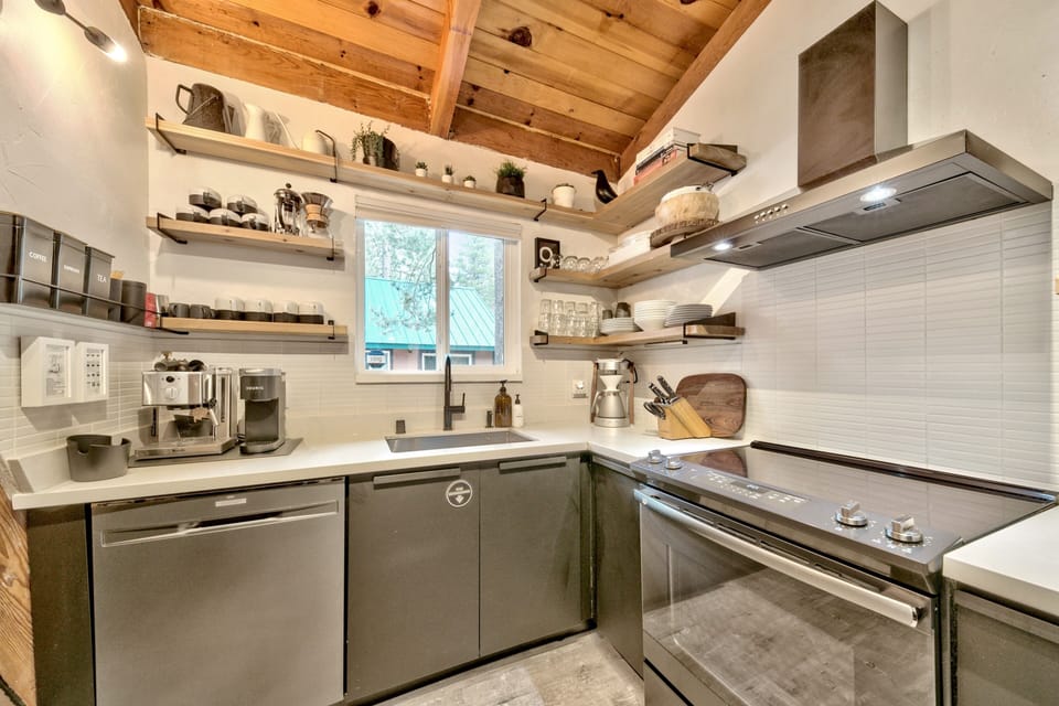 Your fully-equipped kitchen features rustic exposed beams, modern appliances, and open shelving stocked with everything you need to create memorable meals during your stay.