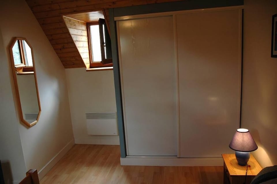 Master bedroom: wall mounted mirror and storage cupboard