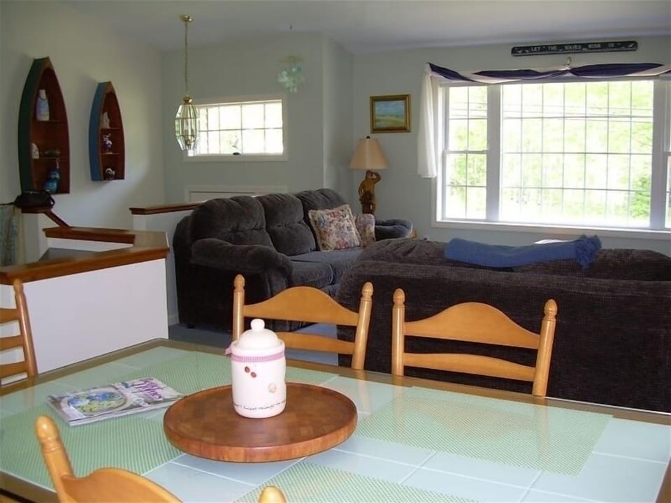 Open concept kitchen,dining,living room with cathedral ceiling and fan.