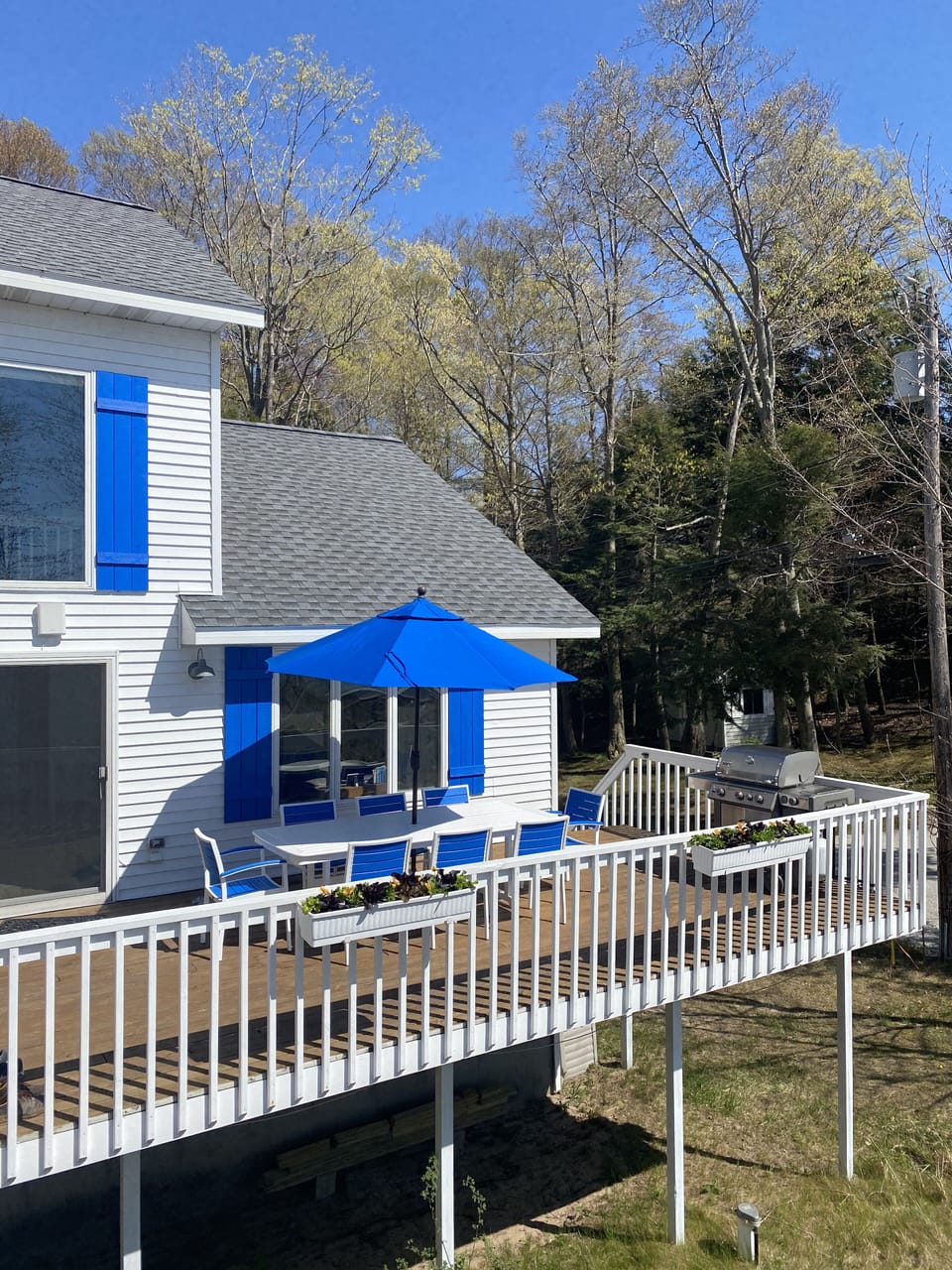 Lake side house deck. New 4 burner Weber gas barbecue as of 2021.