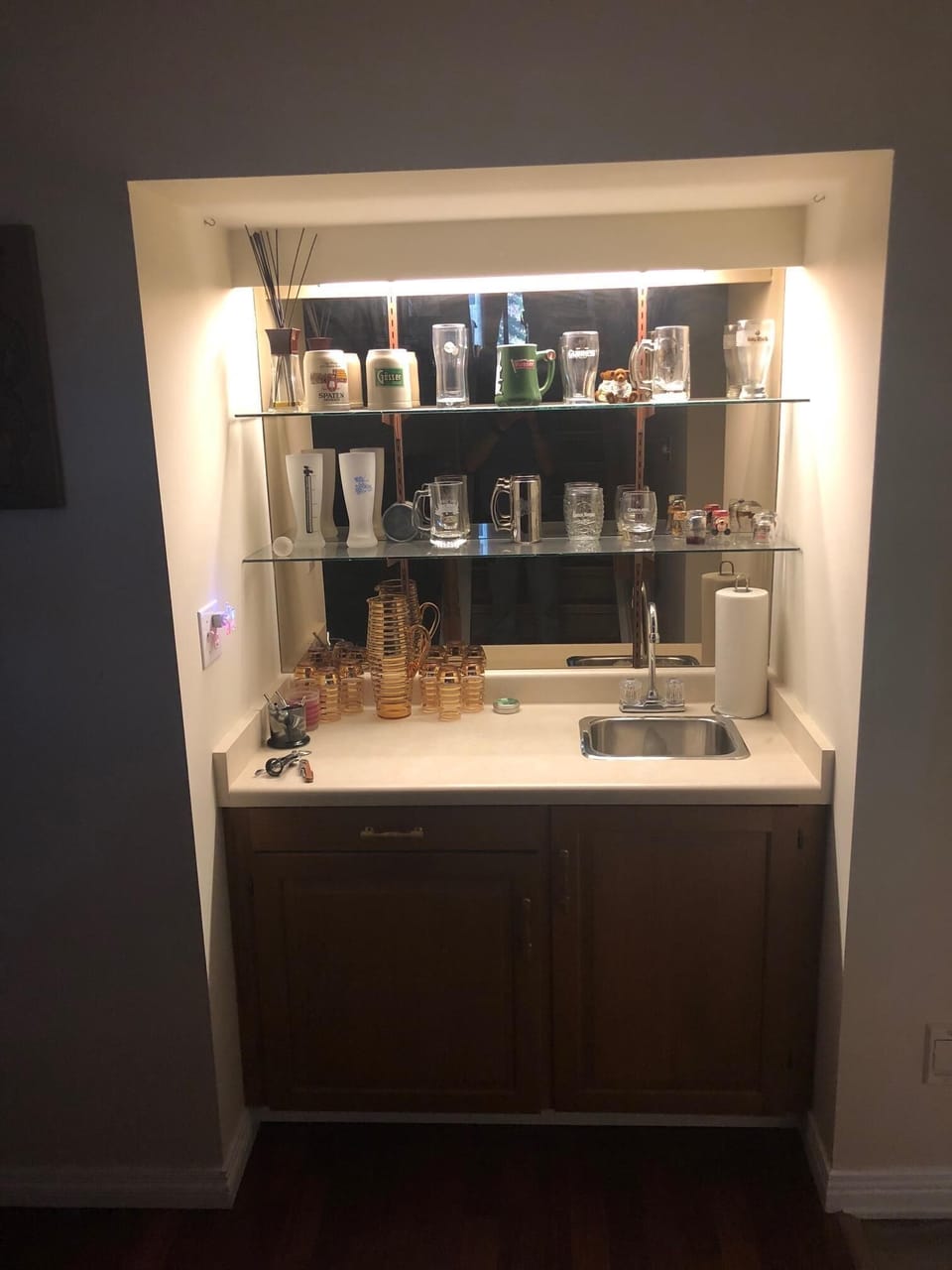 Lower level back lit wet bar with sink to mix the perfect nightcap.