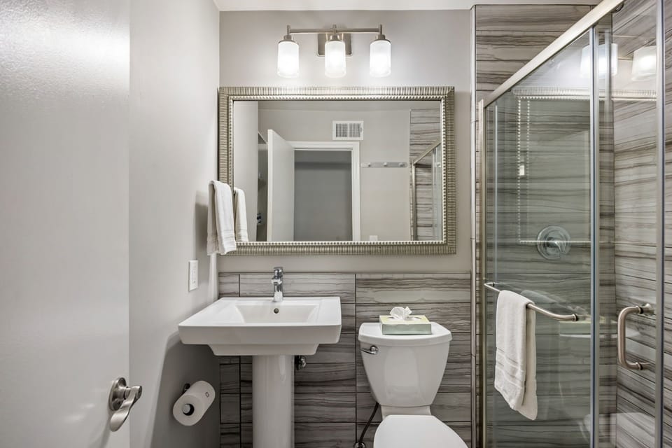 Brookwood Courtyard Condos - Modern Bathroom a Large Mirror