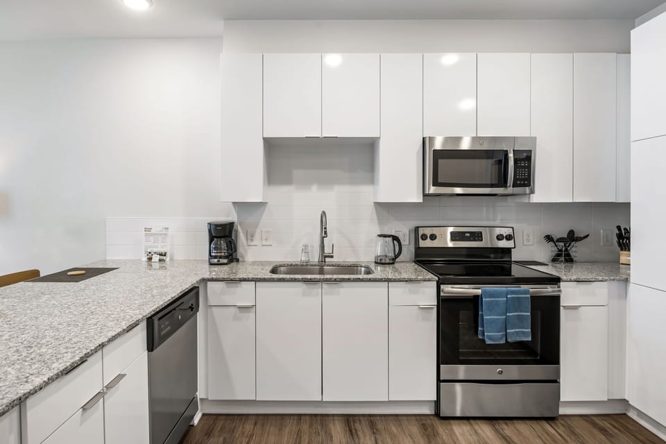 Fully Equipped Kitchen with Island Bar Seating - BCA Furnished Apartments - 1-Bedroom Spectacular Suites