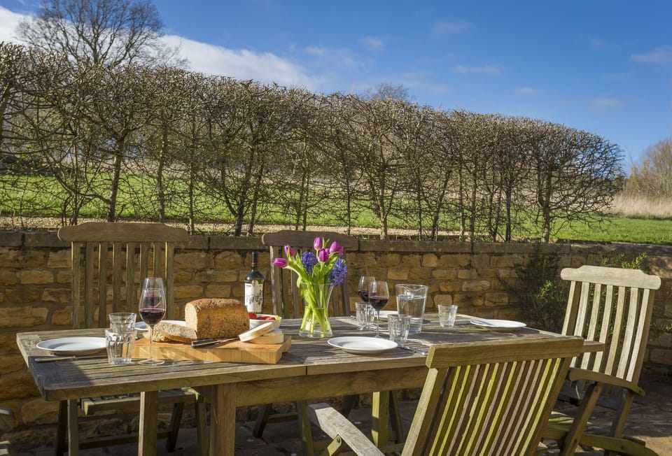 The rear terrace includes garden furniture for al fresco dining