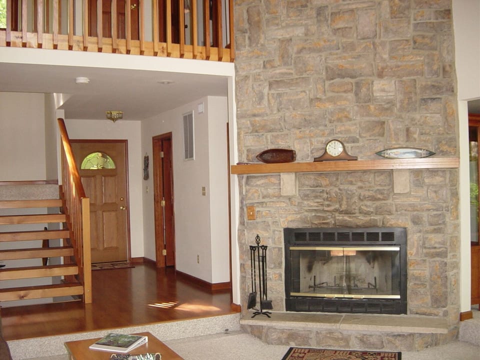 Living room open to dining room and upstairs walkway