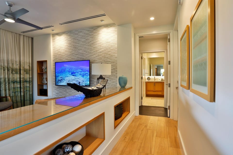 Make your way through the open hallway to the first primary bed & bath