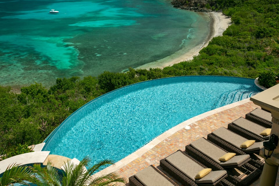 On the rooftop deck, overlooking the infinity pool, hot tub, and Ditleff Beach