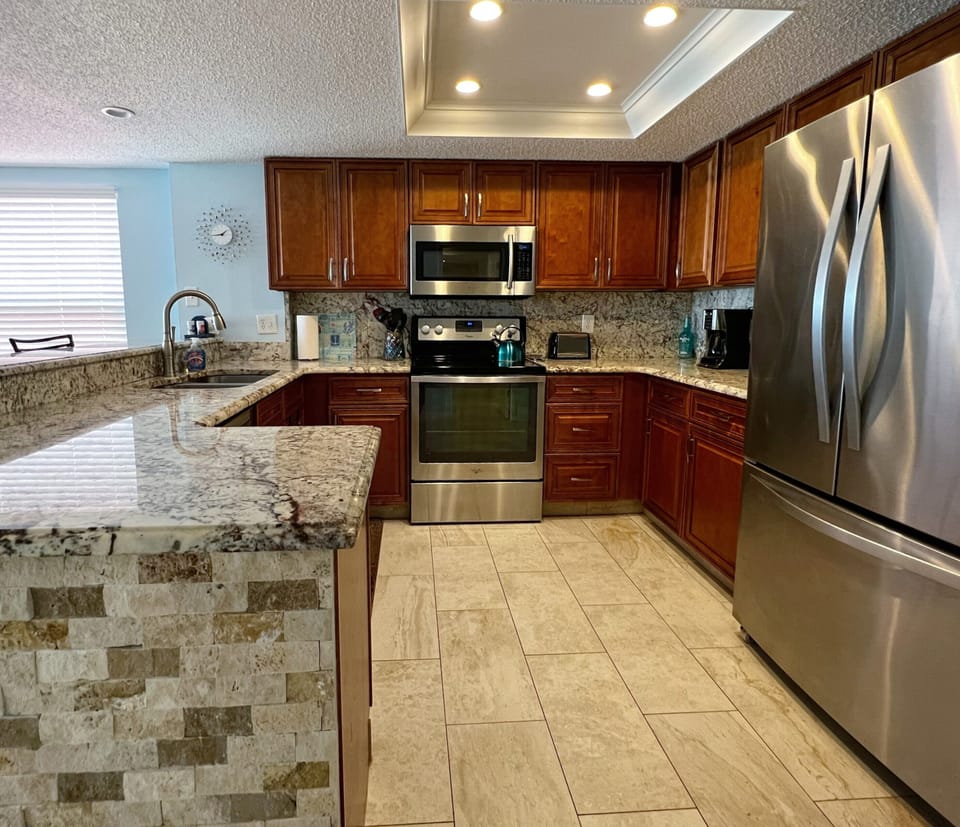 Fully equipped kitchen with updated stainless steel appliances. - Fully equipped kitchen with updated stainless steel appliances. Perfect space for cooking up your favorite homecooked meals and snacks while here on vacation.