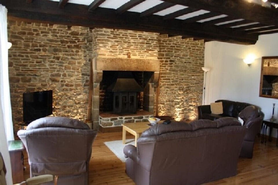 Spacious Living Room with exposed wall,  authentic beams and Log burner