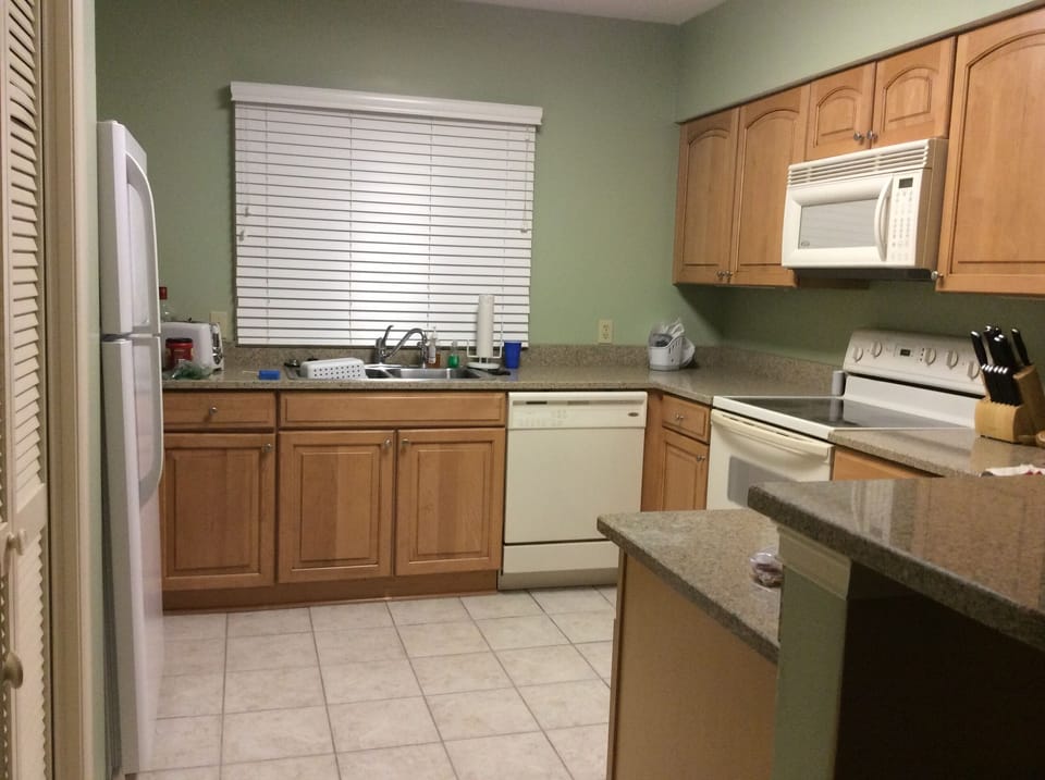 Granite countertops in large fully furnished kitchen. 