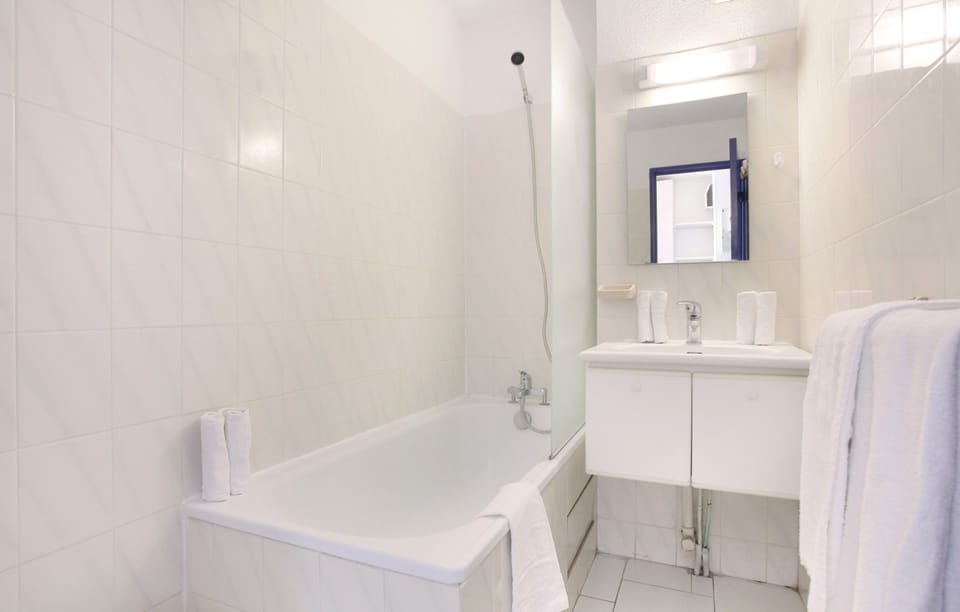 This bathroom features a shower and tub combination.