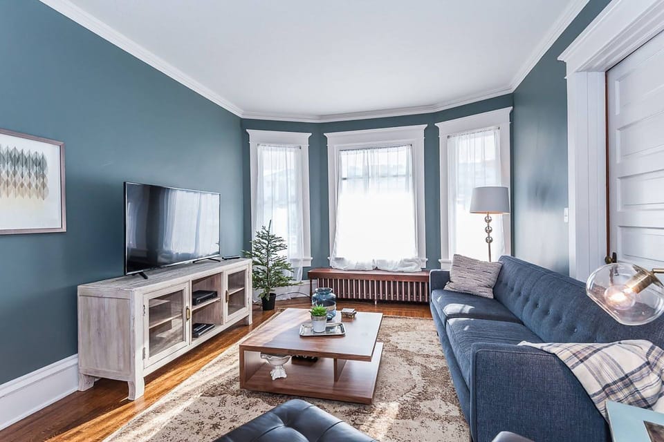 Large living room with cable television and plenty of natural light. 