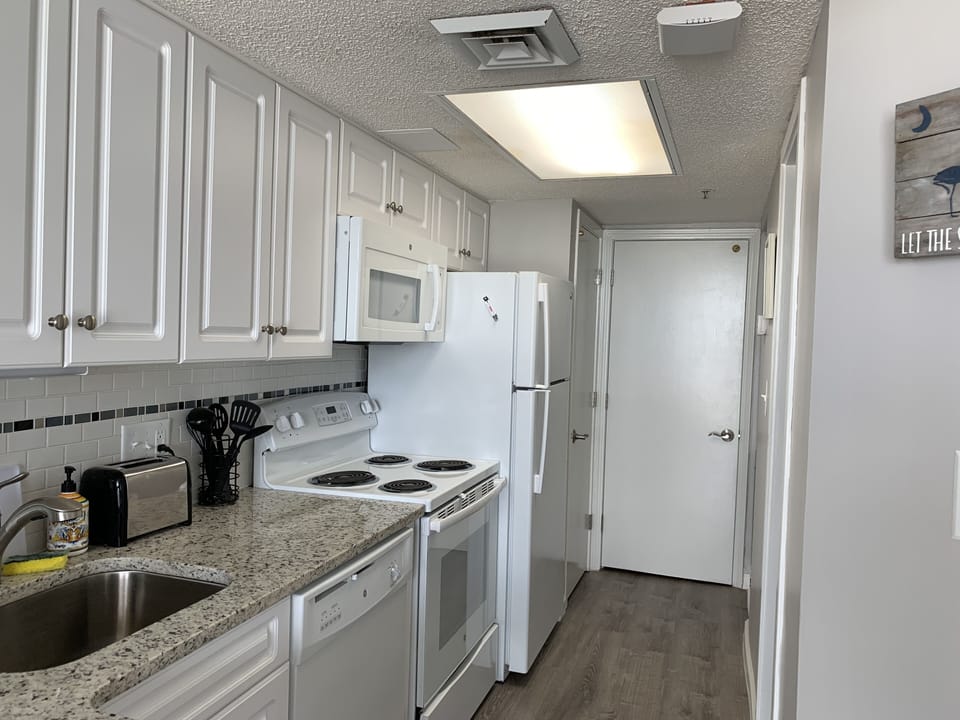 Beautiful granite counters, beachy new cabinets, new greywash floors, all NEW! 