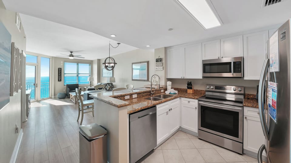 Your fully-equipped kitchen features granite counters and stainless appliances, perfect for preparing meals while enjoying stunning ocean views.