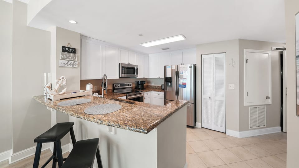 Step into your bright, open-concept kitchen with granite countertops and modern appliances—perfect for preparing meals together.