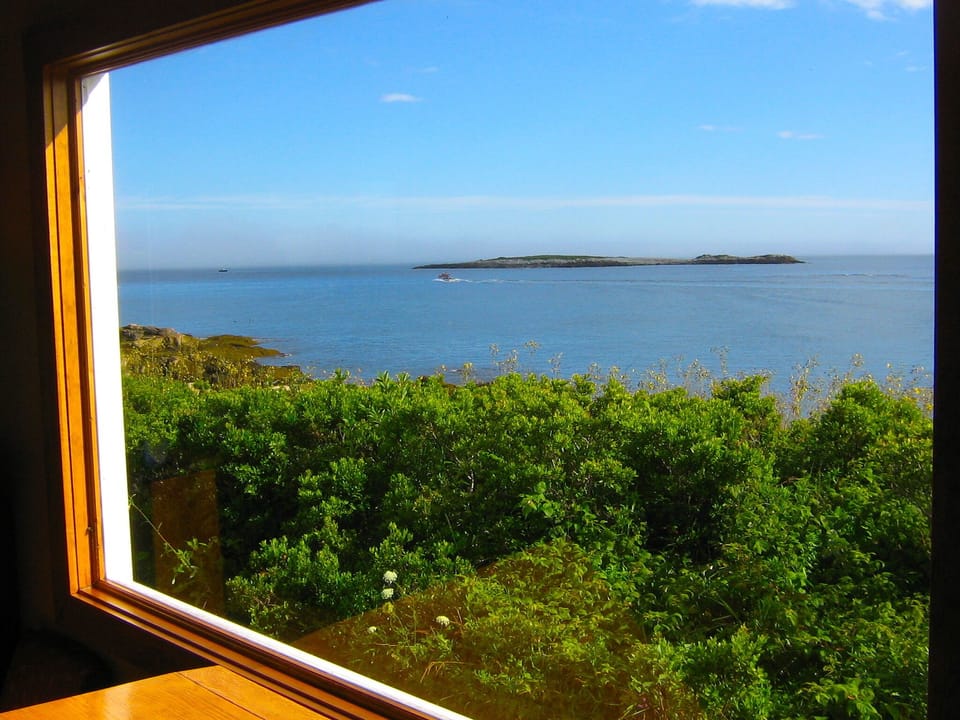 living area window, lobster boat in distance, offshore islands in view