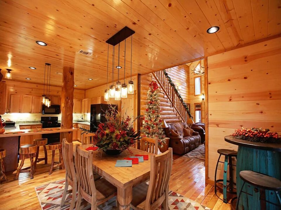 Enjoy meals and memorable moments in this open-concept dining and living space, where rustic charm and festive touches create a warm, welcoming atmosphere.