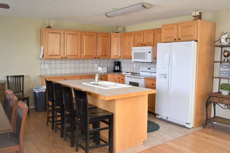 Spacious kitchen with warm wood finishes—perfect for gathering, cooking, and creating lasting memories.