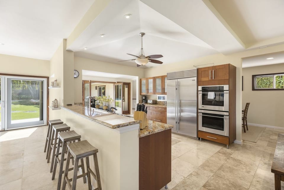 A cook’s dream with ample storage, natural flow, and warm finishes.