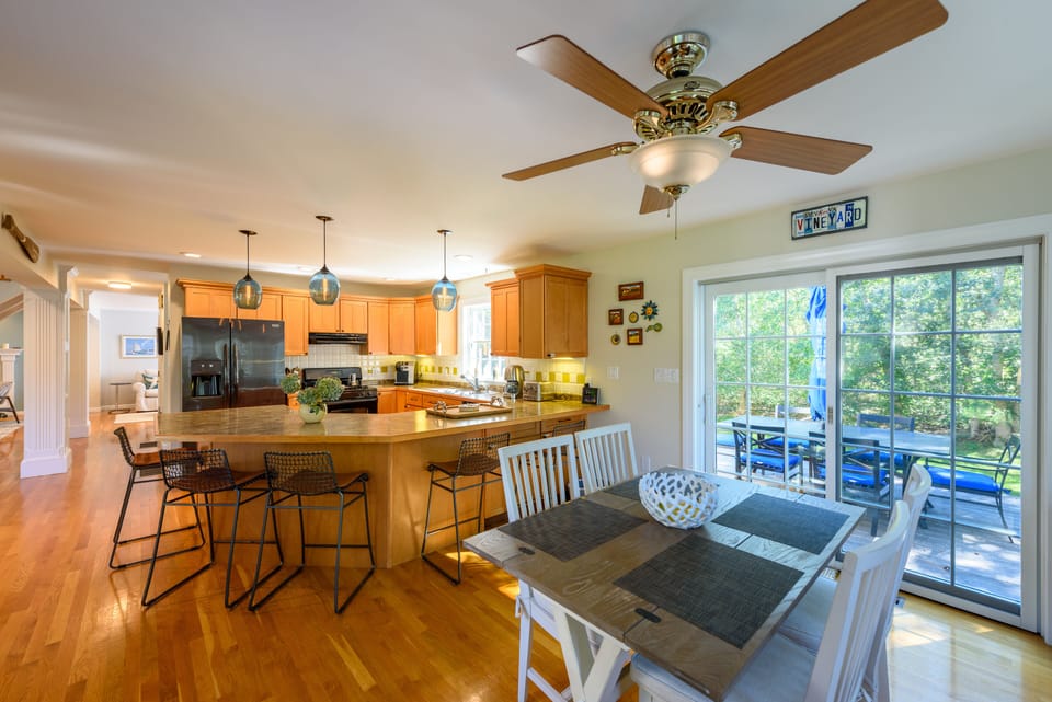 Kitchen with concave island and walk out to deck.
