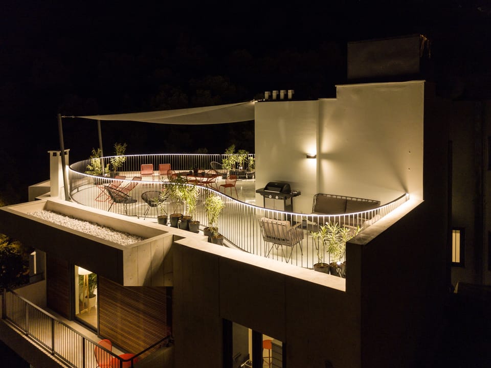 Roof terrace at night with BBQ area